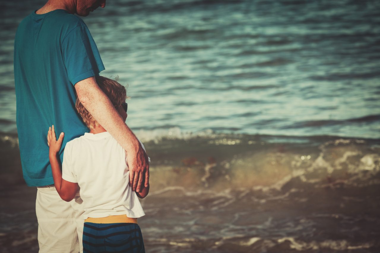 father and little son hug at beach, family at beach