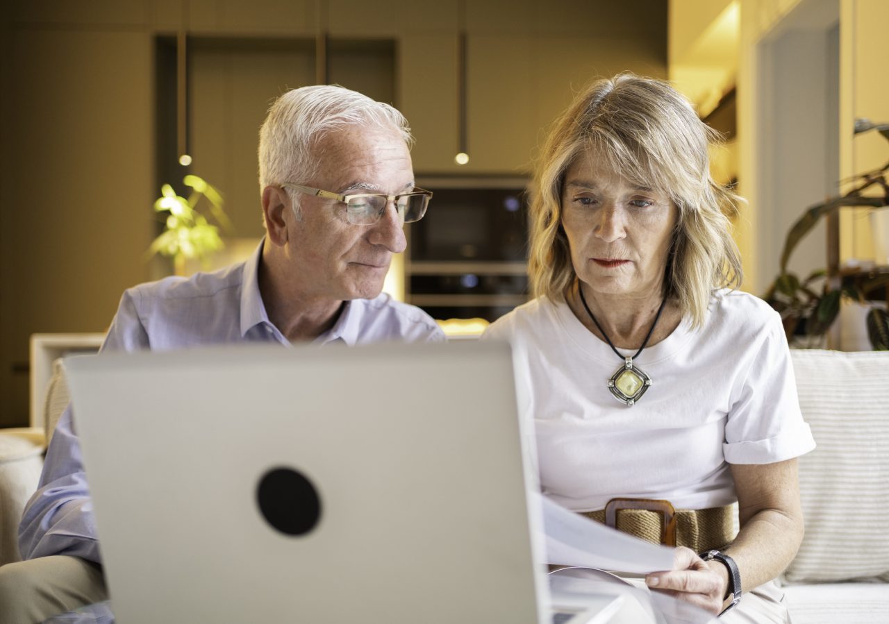 Senior couple using laptop